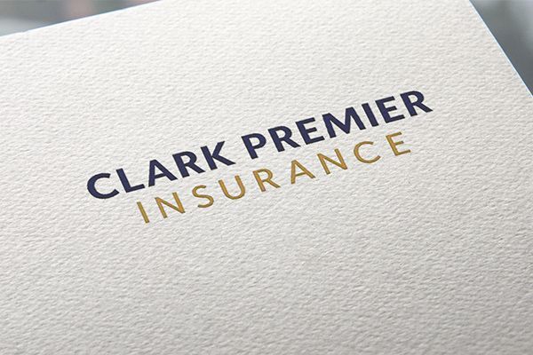 Clark Premier Insurance logo. Blue text on top, gold text below.