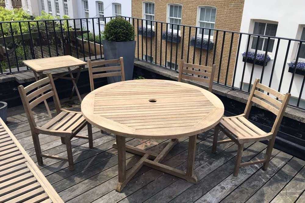 Wooden garden seating set that has been cleaned and treated through our furniture restoration service.