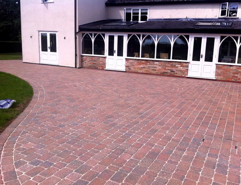 Large red paving pressure washed by block paving cleaning service in Hull