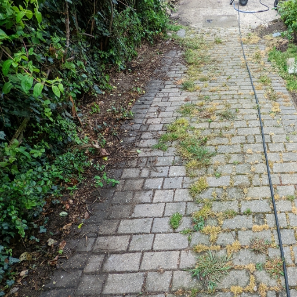 Block paved driveway cleaning in Hull. Gray paving covered in dirt, moss and weeds