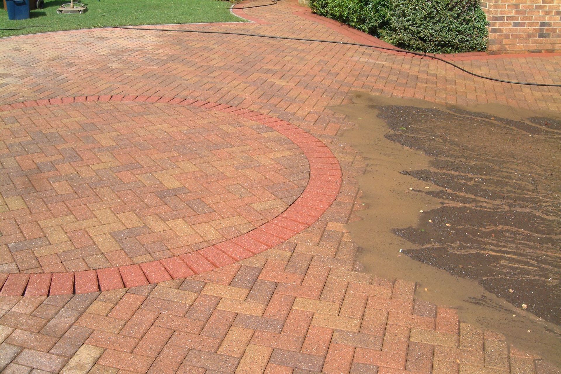 Red block paved driveway, pressure washed and cleaned by Hedon exterior cleaning ready to have block paving sealer applied.