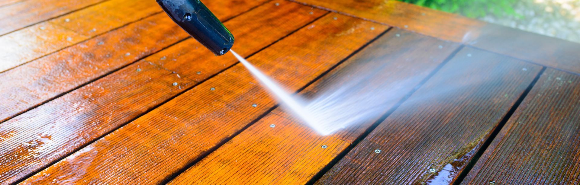 Decking cleaning service removing algae and dirt by pressure washing
