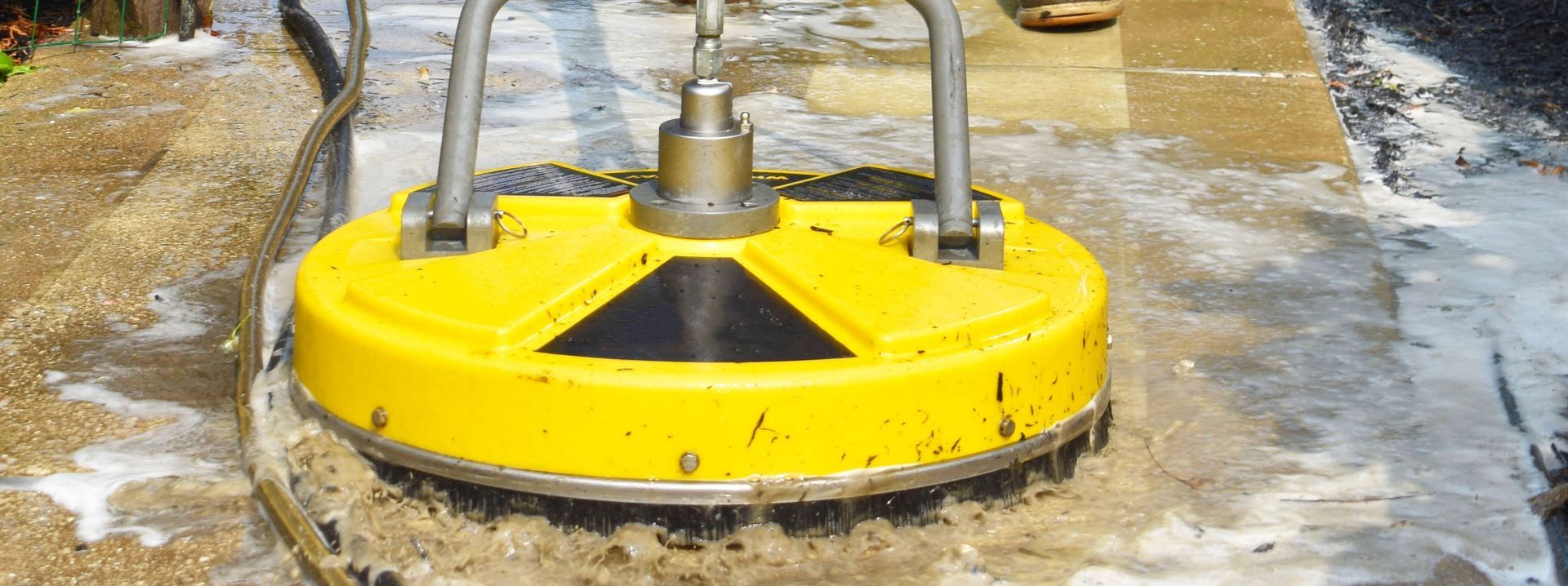 Pressure washing paved area with specialist surface cleaner