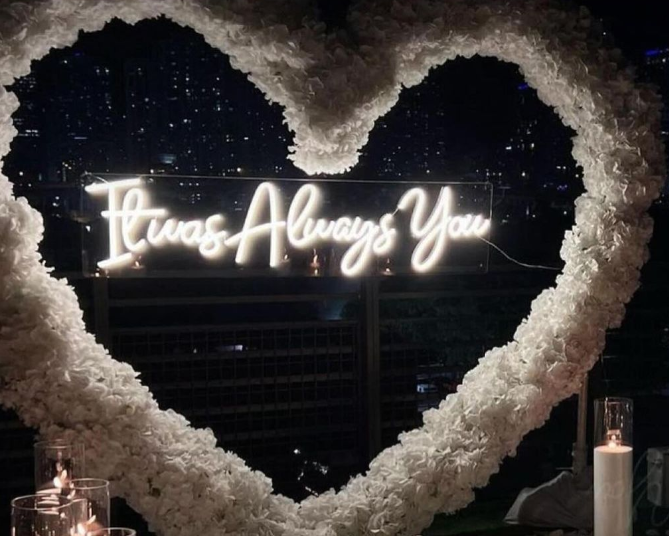 a heart made of flowers with a neon sign that says i was always you