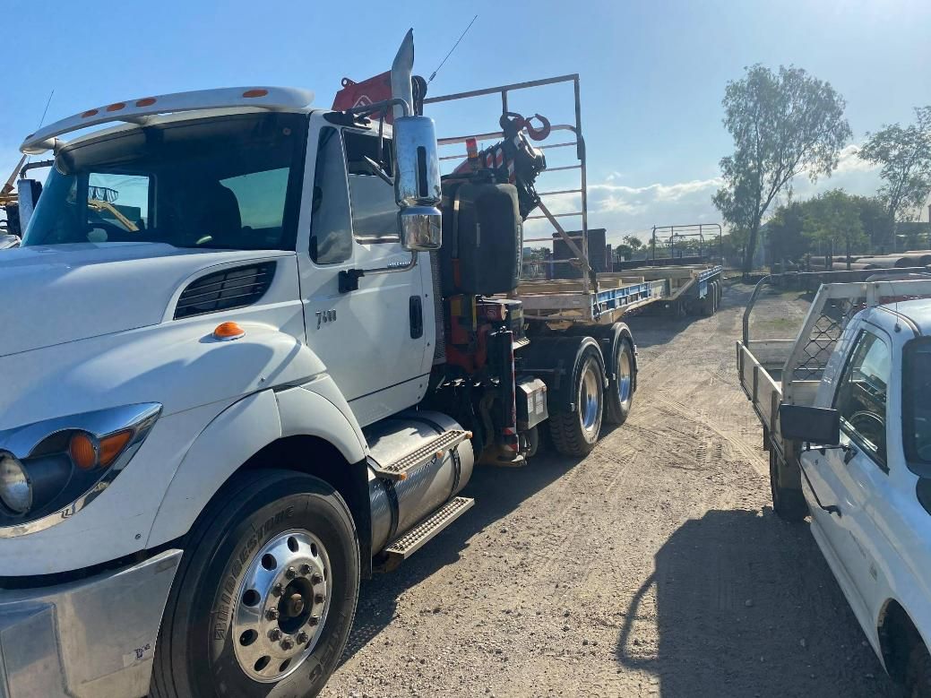 A White Truck with A Crane on The Back Is Parked on A Dirt Road — White's Truck & Machinery Hire in Bouldercombe, QLD