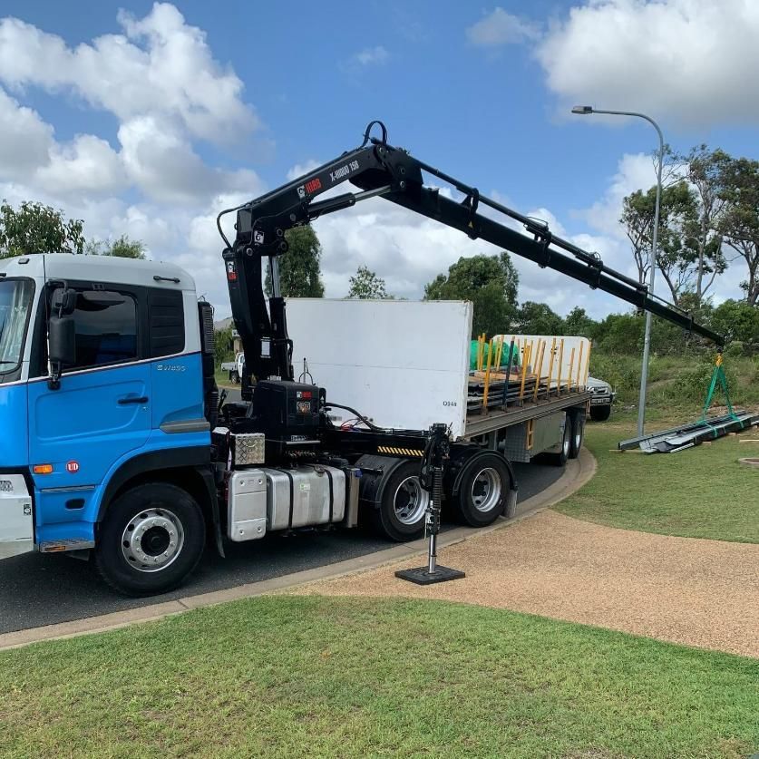 A Blue Truck with A Crane on The Back Is Parked in A Grassy Area — White's Truck & Machinery Hire in Bouldercombe, QLD