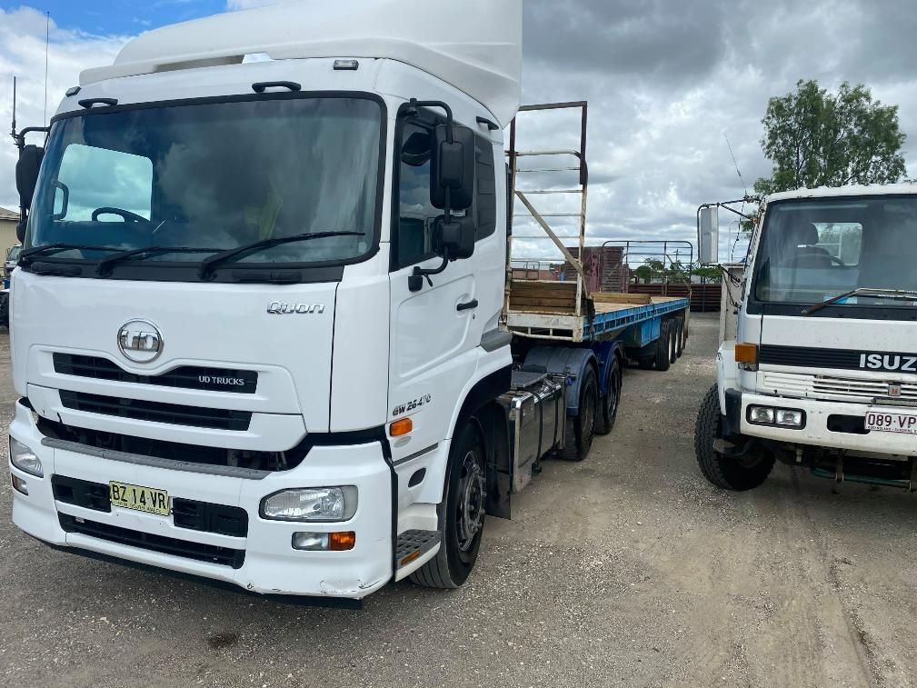 Two White Trucks Are Parked Next to Each Other on A Dirt Road — White's Truck & Machinery Hire in Bouldercombe, QLD