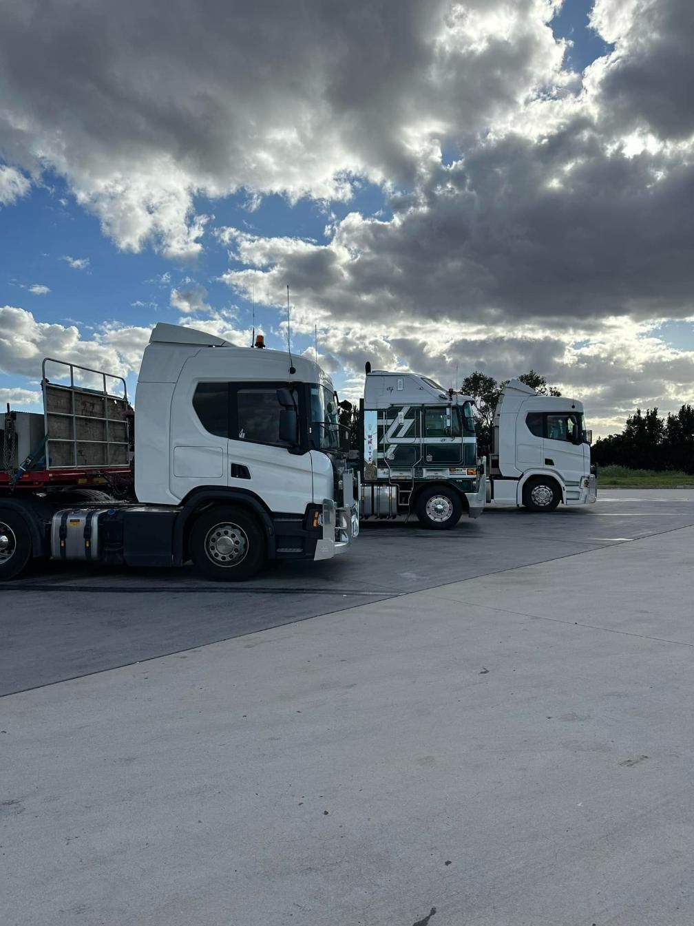 Three Semi Trucks Are Parked Next to Each Other in A Parking Lot — White's Truck & Machinery Hire in Bouldercombe, QLD