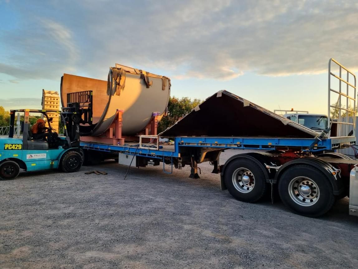 A forklift is carrying a large object on the back of a semi truck — White's Truck & Machinery Hire in Bouldercombe, QLD
