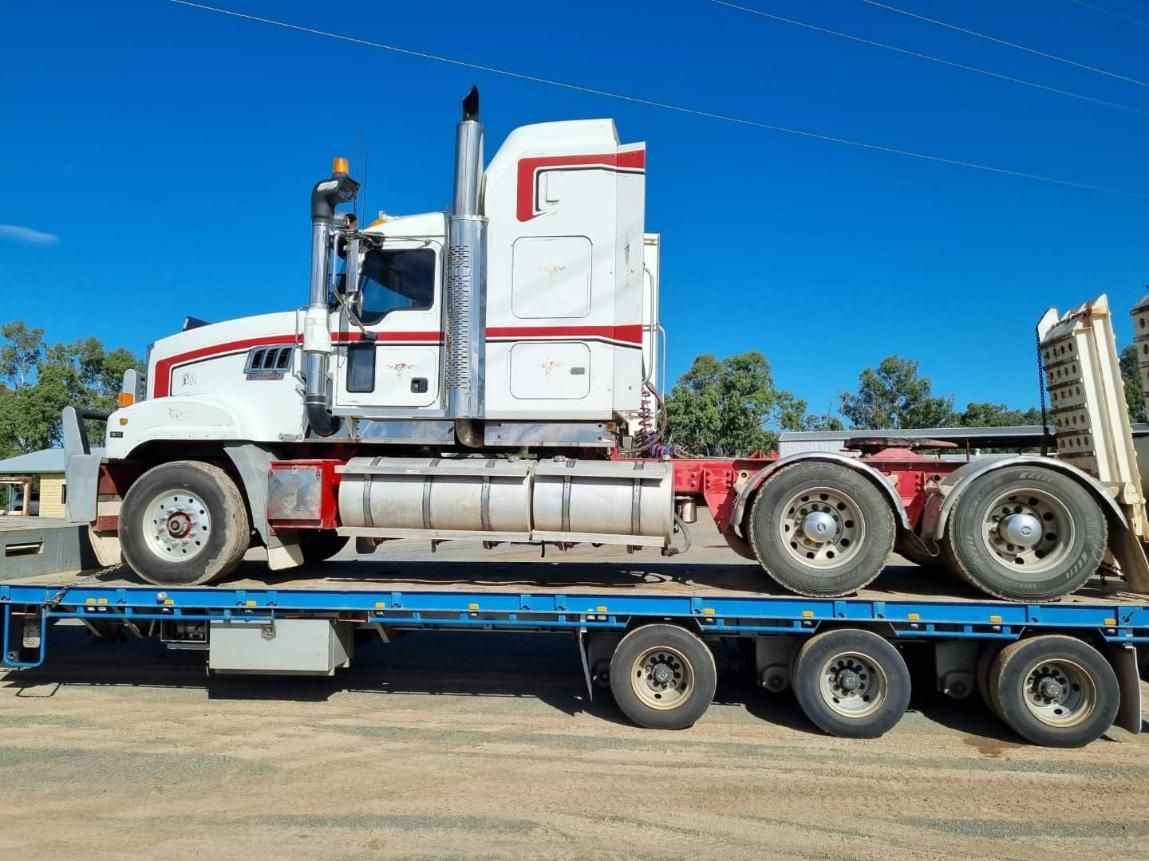 A Semi Truck Is Sitting on Top of A Flatbed Trailer — White's Truck & Machinery Hire in Bouldercombe, QLD