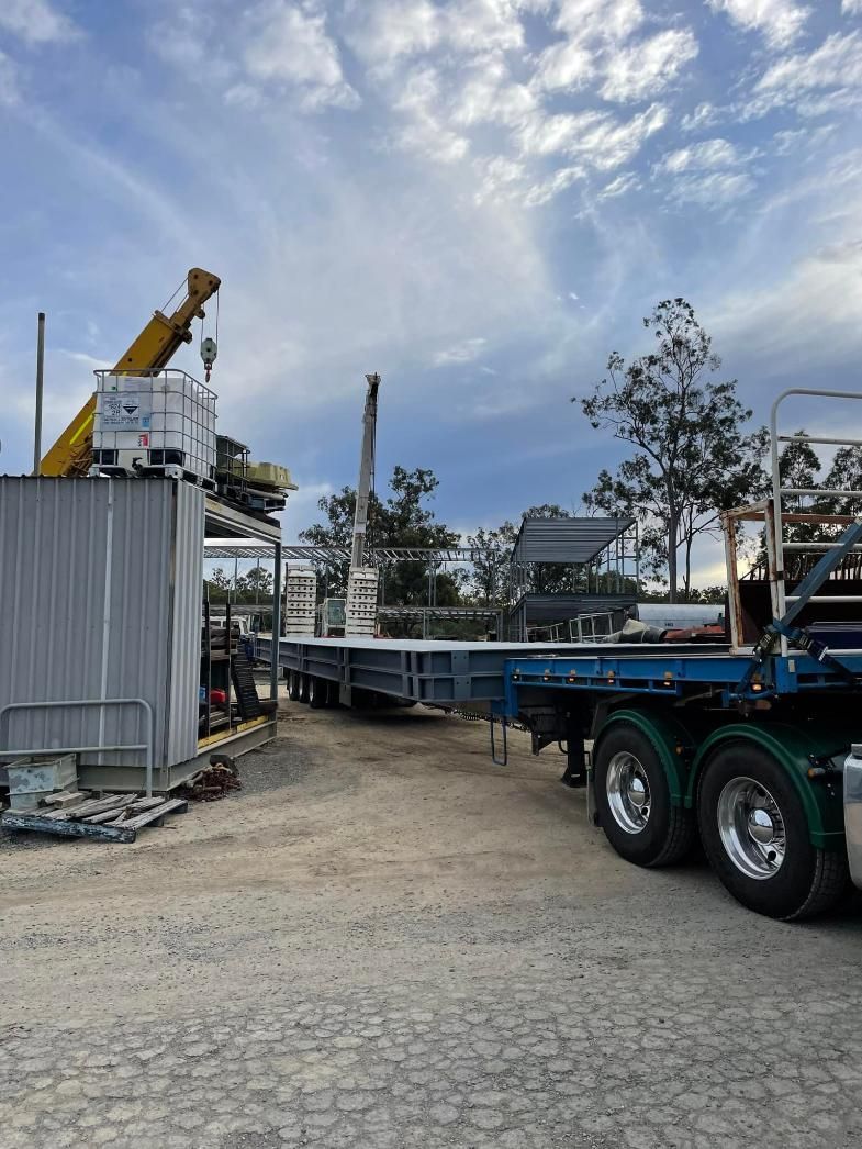 A Truck Is Parked in A Dirt Lot Next to A Building — White's Truck & Machinery Hire in Bouldercombe, QLD