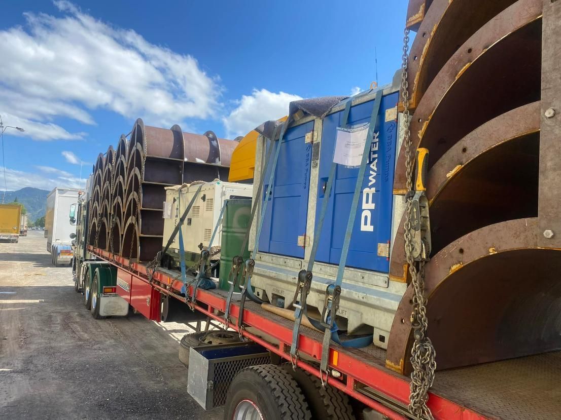 A Red and Blue Semi Truck Is Carrying a Lot of Cargo — White's Truck & Machinery Hire in Bouldercombe, QLD