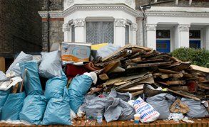 A huge pile of rubbish outside a house