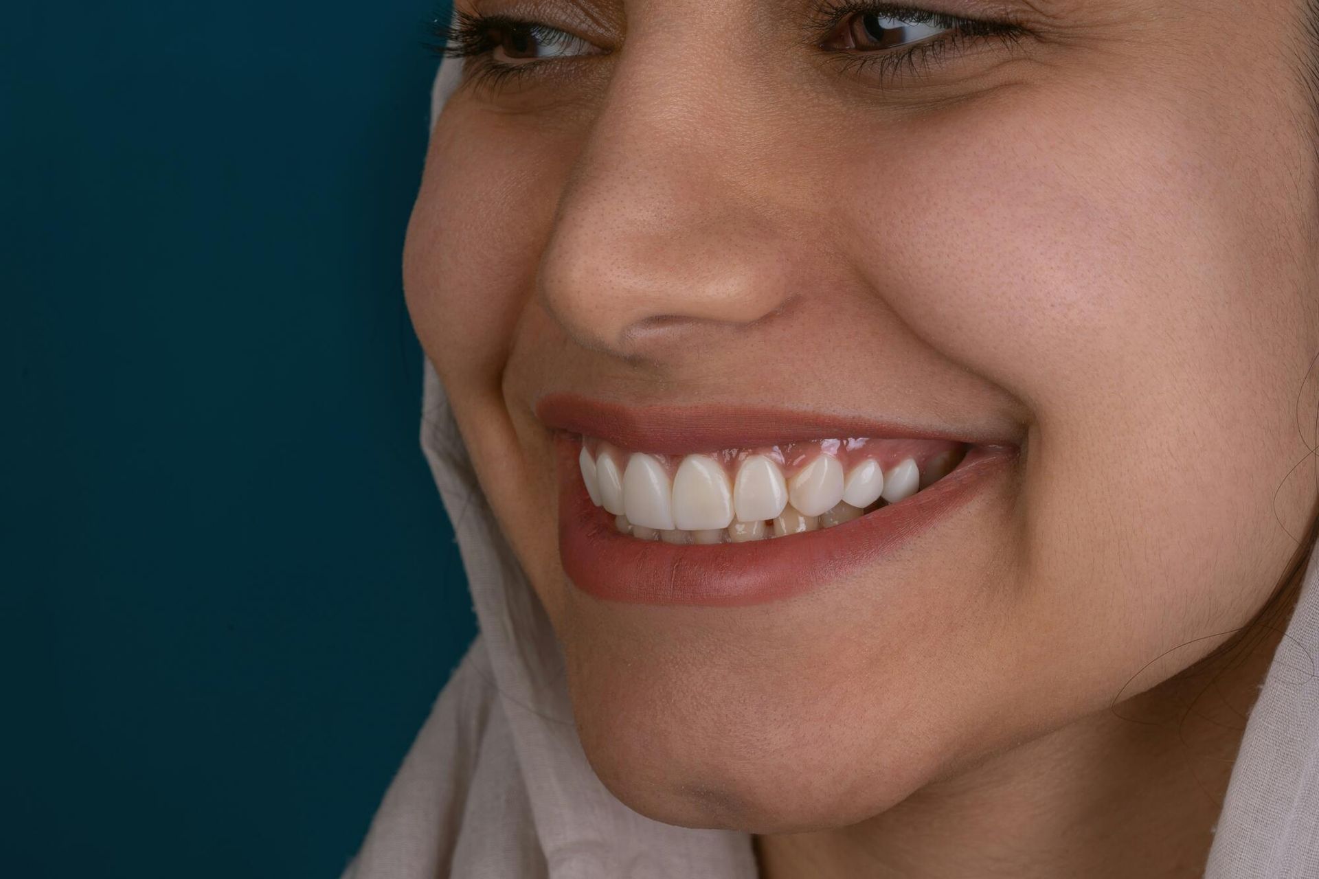 A close up of a woman 's smile with white teeth.