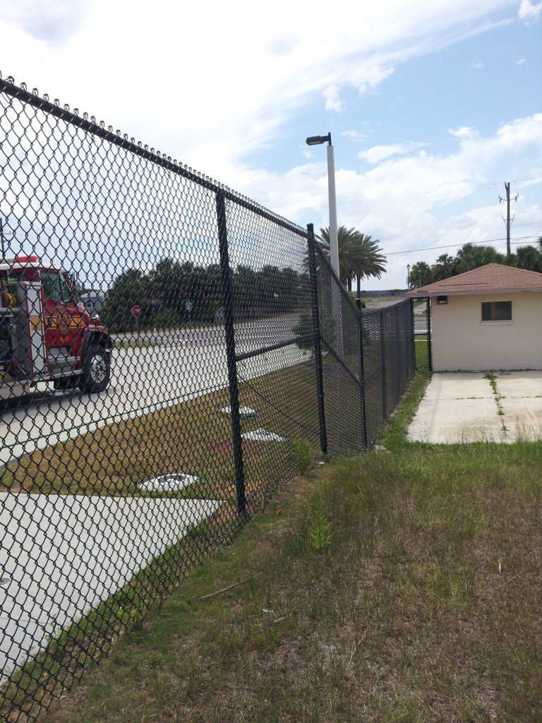 Black Vinyl Chain Link Fence Beside Road — Jacksonville, FL — Newsom Fence