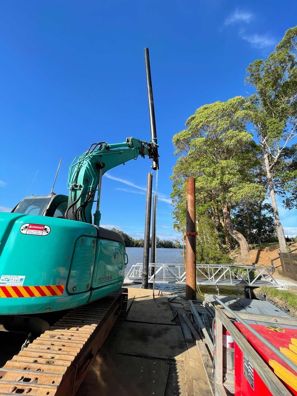 Earthmoving Equipment Building Floating Deck Pile On The River — Salvaging in Port Stephens, NSW
