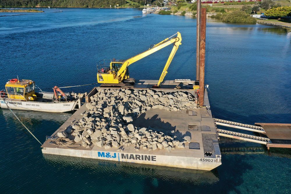 Yellow Excavator Along the Coast — M&J Marine Services in Medowie, NSW