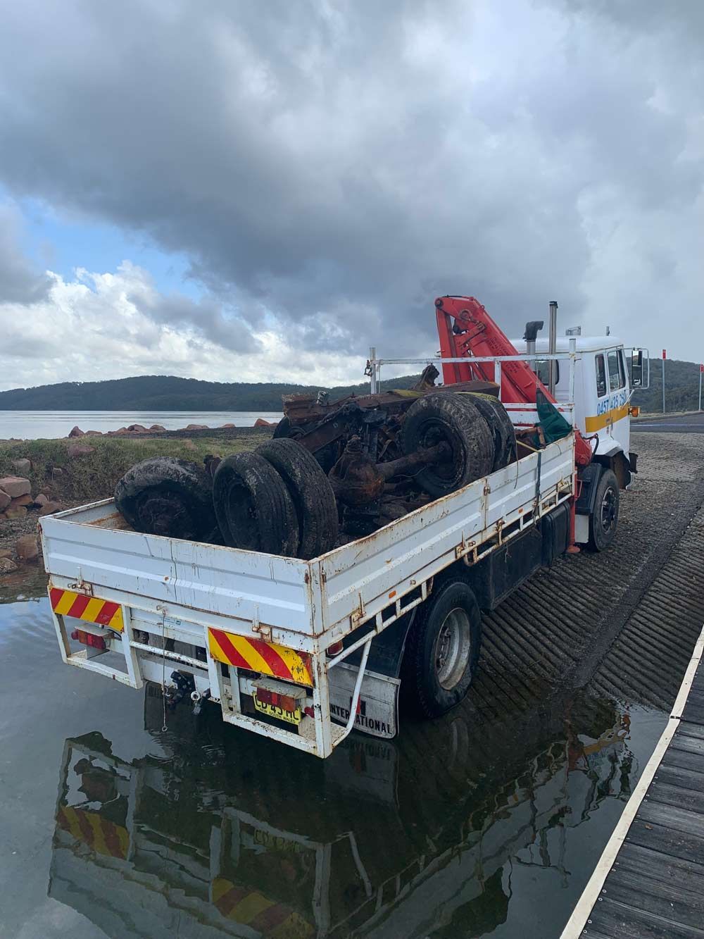 Old Tire And Part Od The Vehicle Loading On The Truck — Salvaging in Port Stephens, NSW