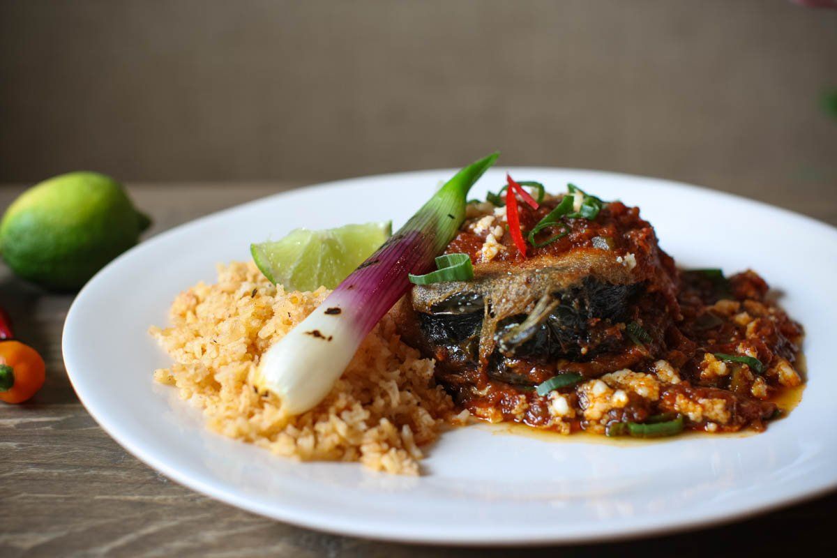 A plate of food with rice and vegetables on a table.