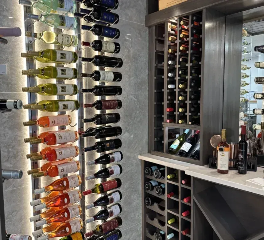 Wine cellar: Various wine bottles stored in vertical and horizontal racks; built-in cabinets and countertop.
