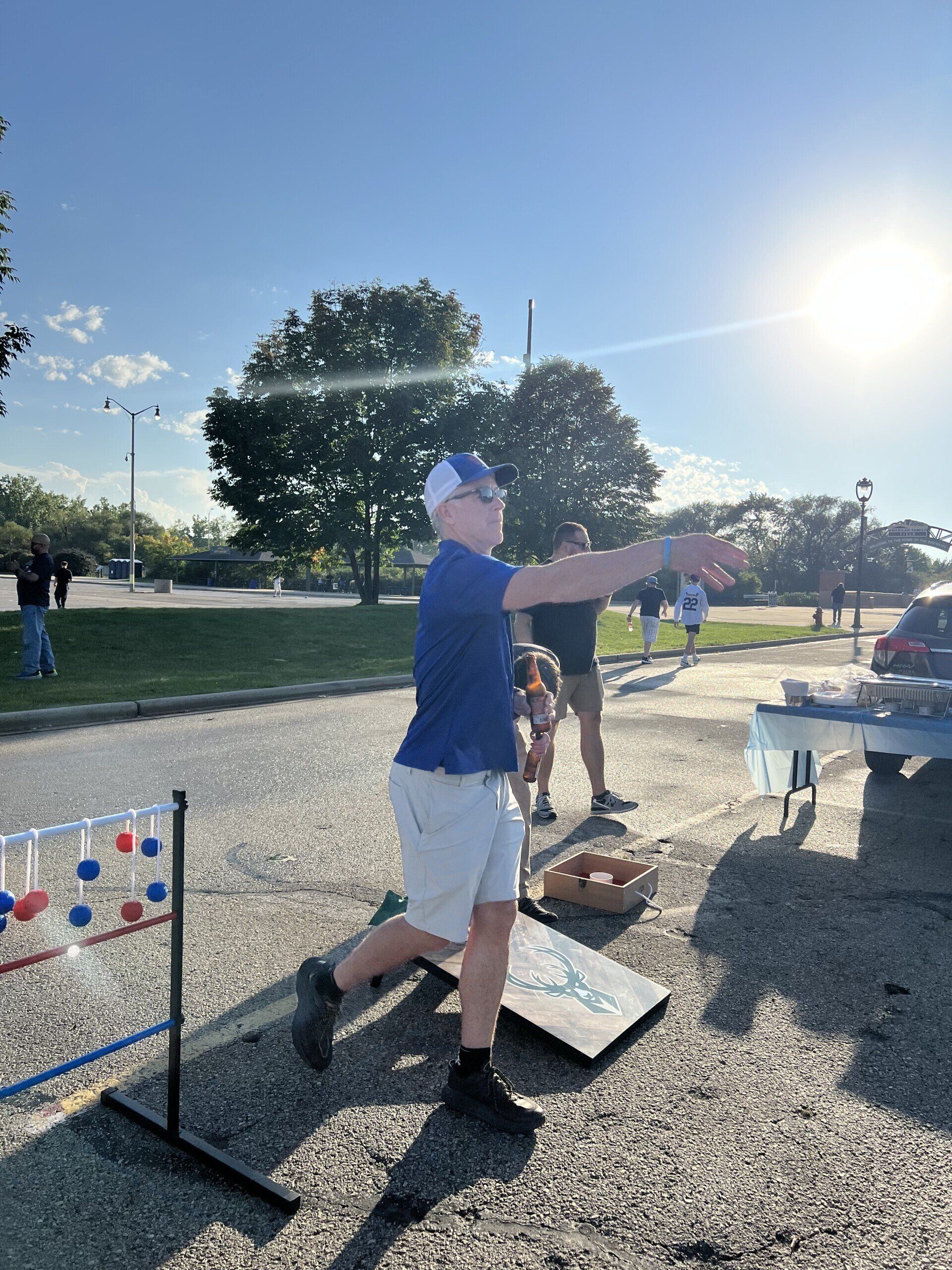 A man is throwing a frisbee in a parking lot