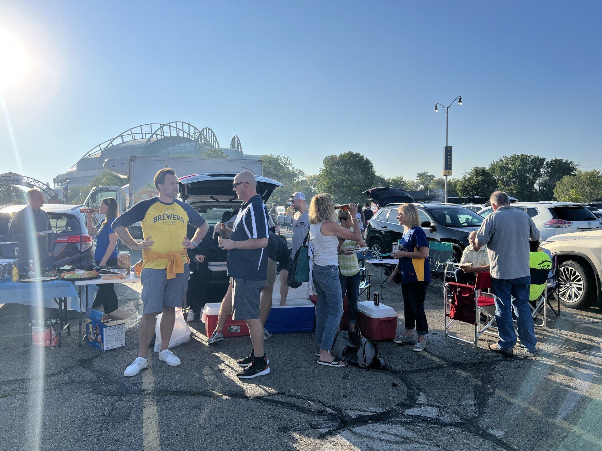 A group of people are standing in a parking lot.