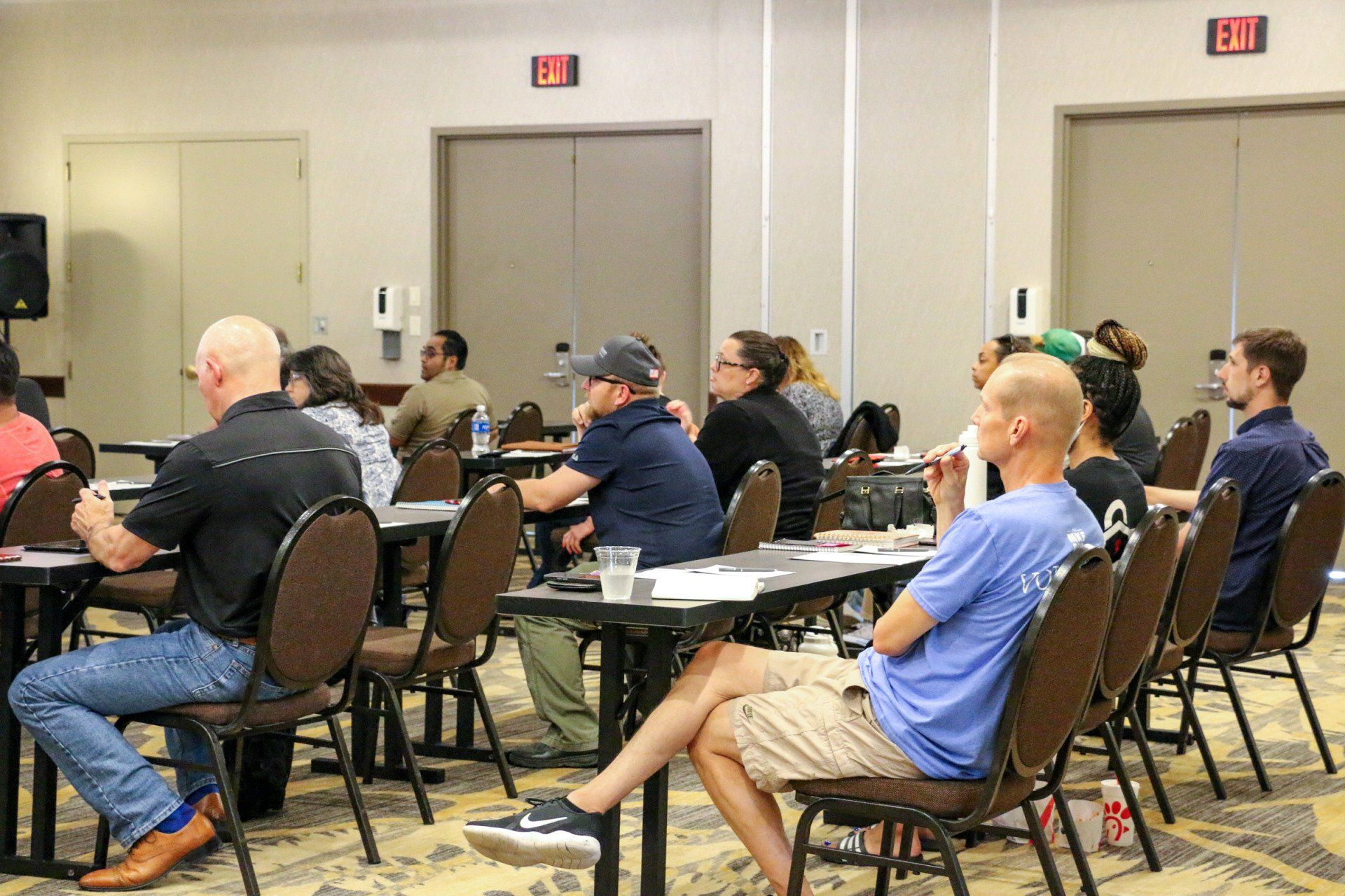 A group of people are sitting at tables in a room.
