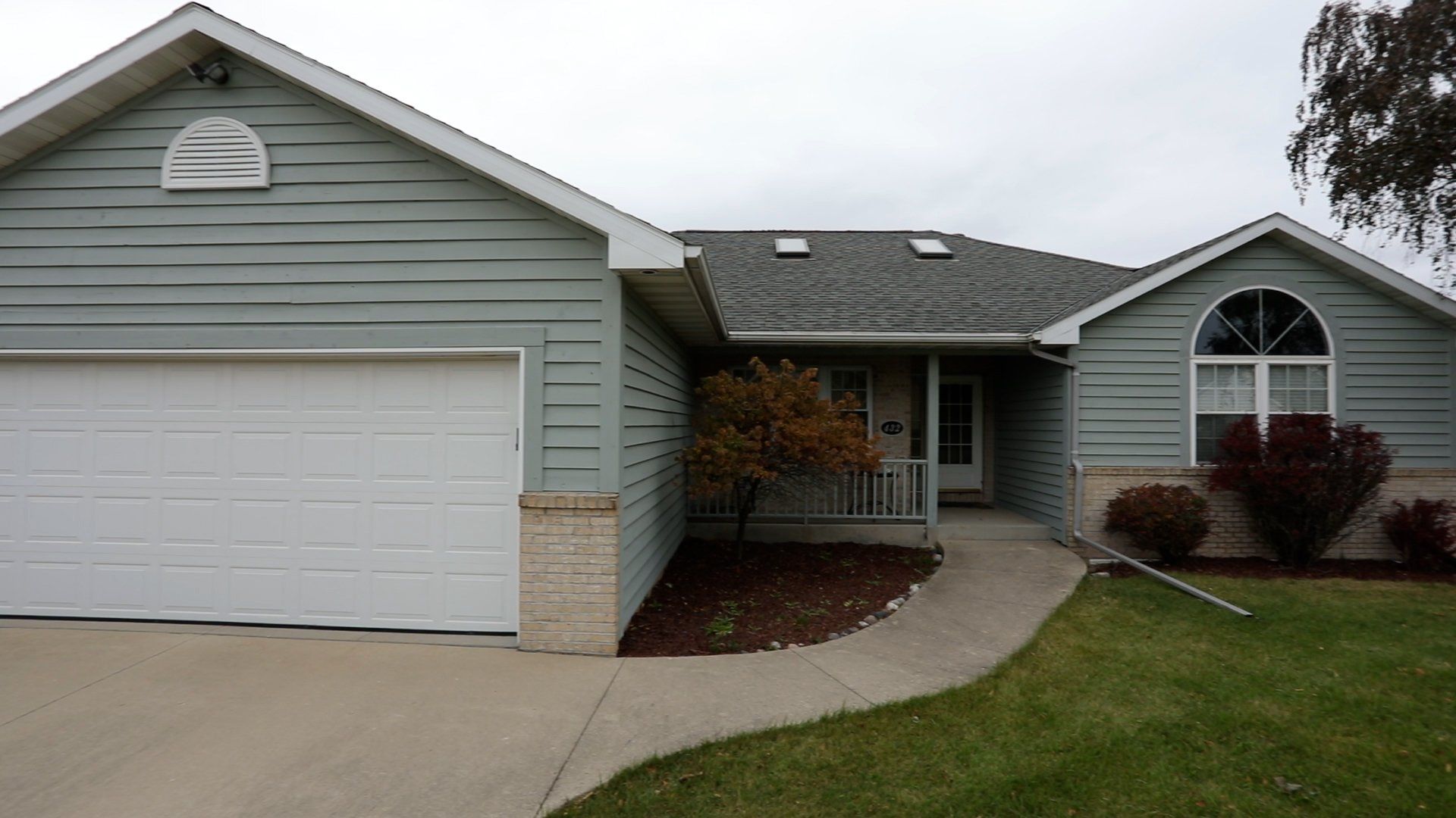 The front of a house with a white garage door