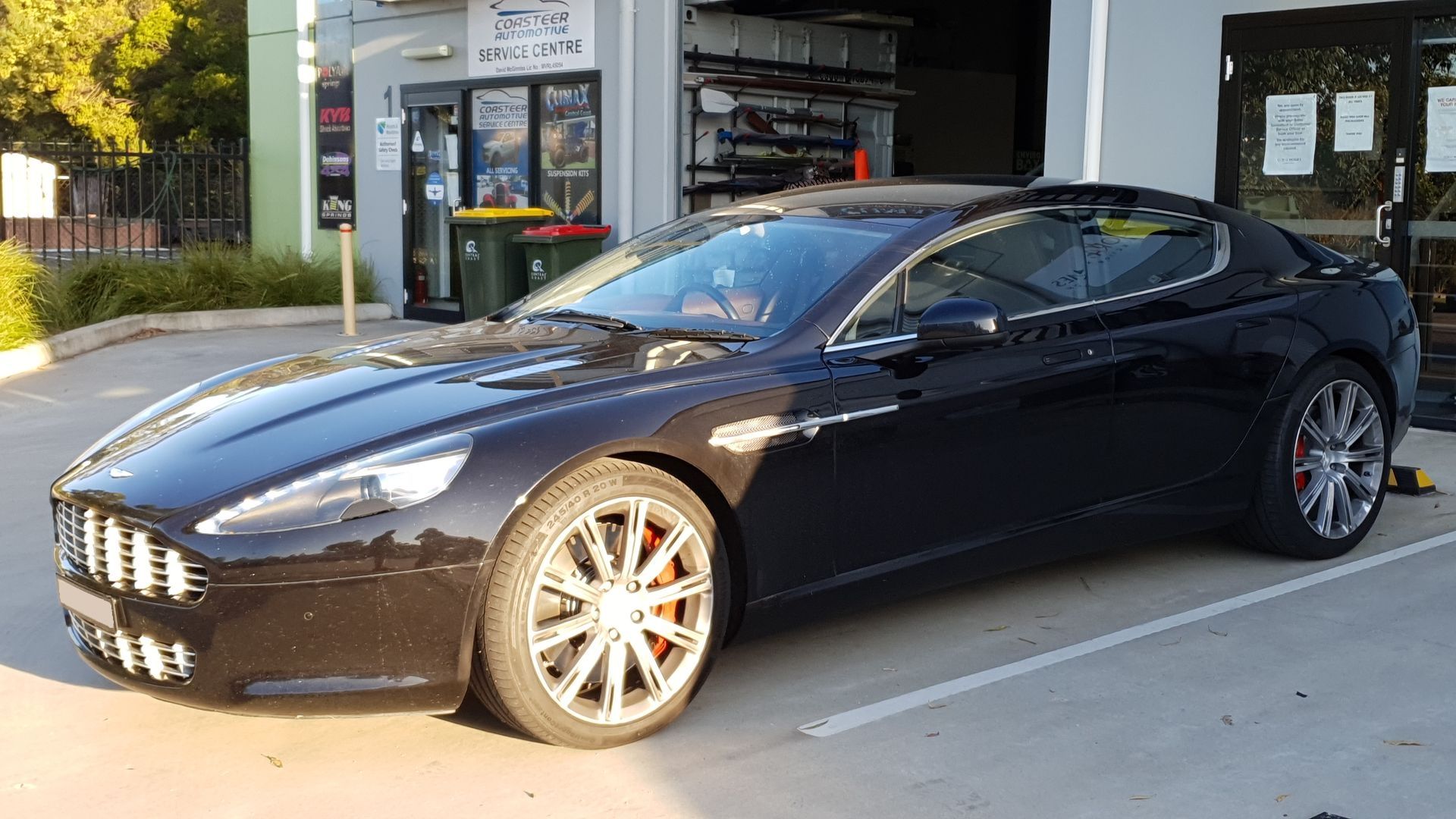 Black Aston Martin Parked Outside A Shop With Tinted Windows — Coasteer Automotive In Tuggerah, NSW
