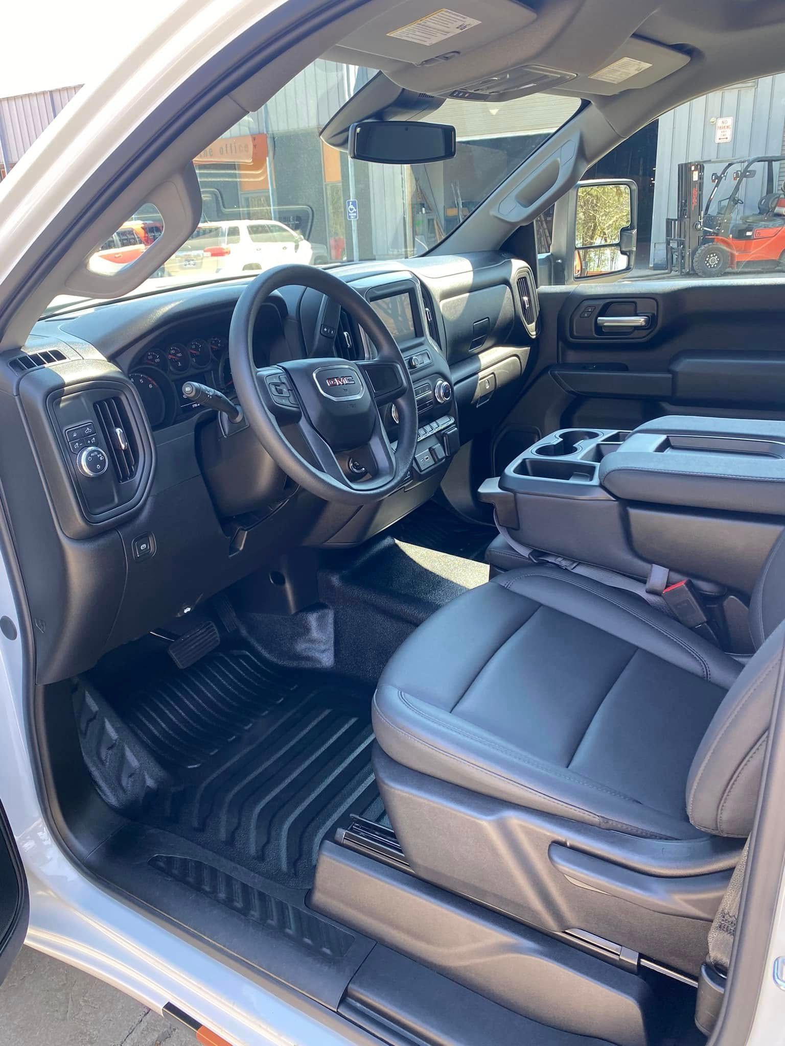 Luxurious SUV interior with black leather seats, dashboard, and open driver’s door