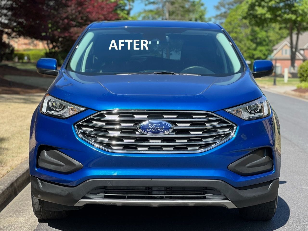 a blue ford edge is parked on the side of the road  at Forsyth Collision in Cumming GA