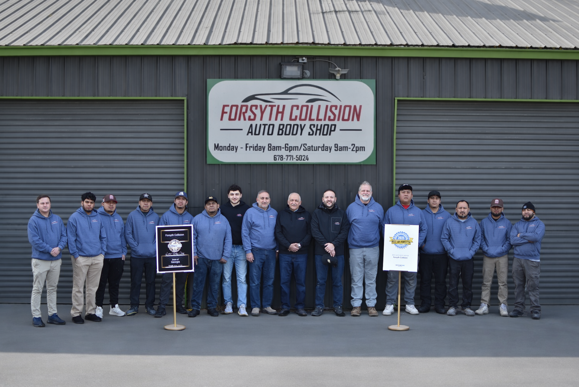 a group of people standing in front of a building that says forsyth collision