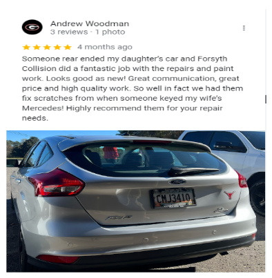 a silver car is parked in a parking lot with a review from andrew woodman