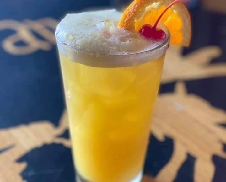 Chicken wings in a basket, with three dipping sauces.