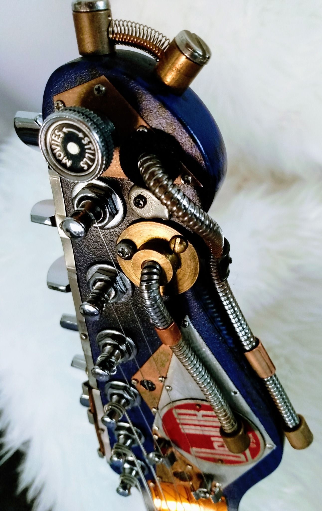 A close up of a guitar headstock with a lots of parts on it symbolic of marketing integration. 