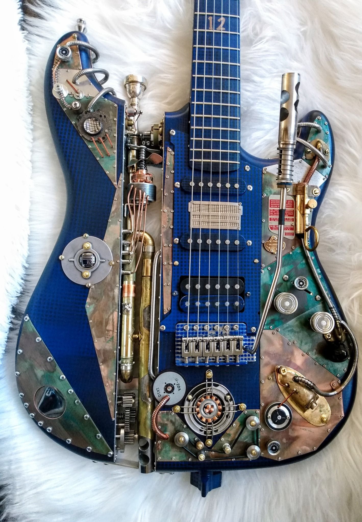 A blue electric guitar with a lot of various parts on it symbolic of marketing integration. 