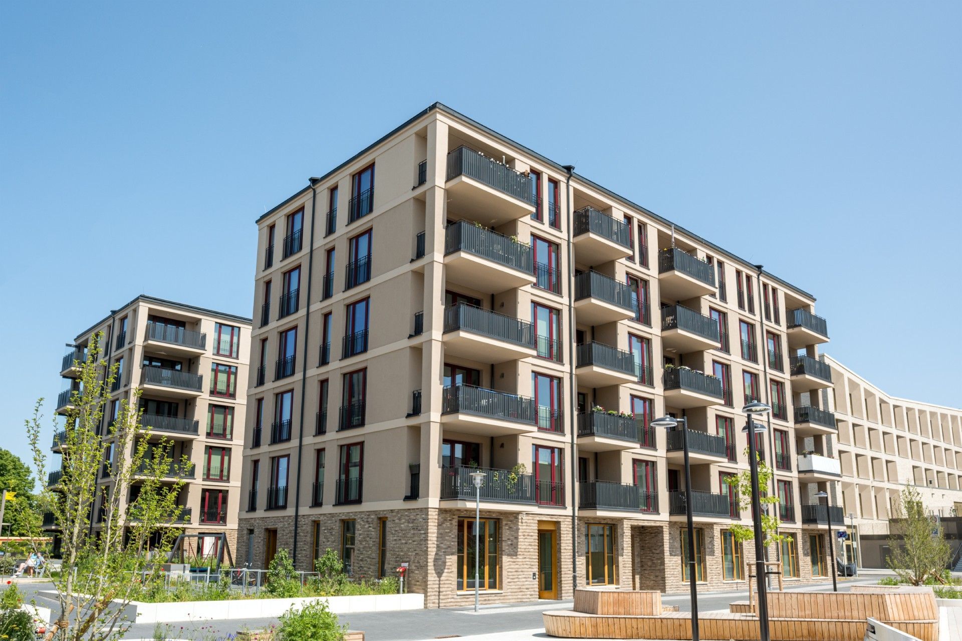 A large apartment building with a lot of windows and balconies.