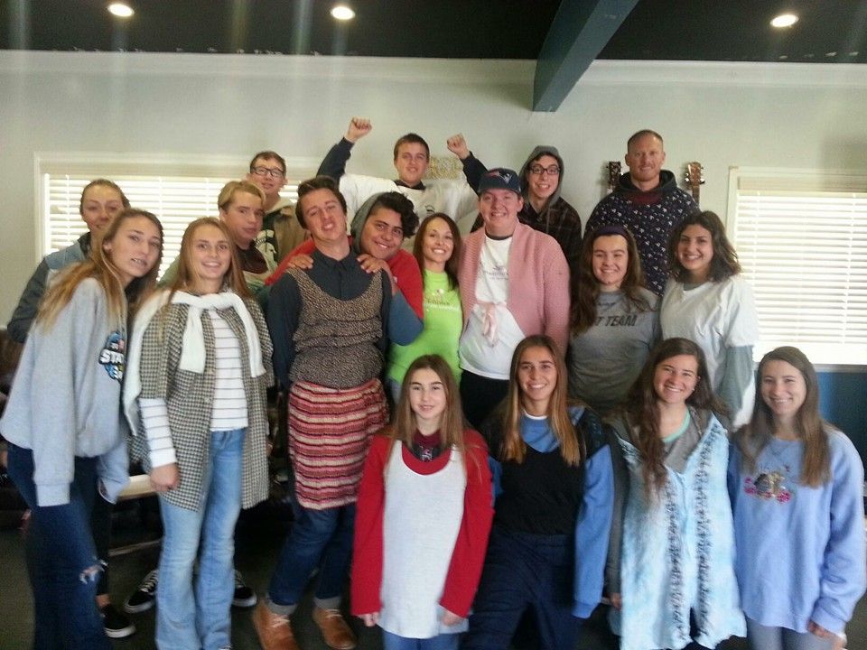 Group of diverse people smiling, posing together indoors.