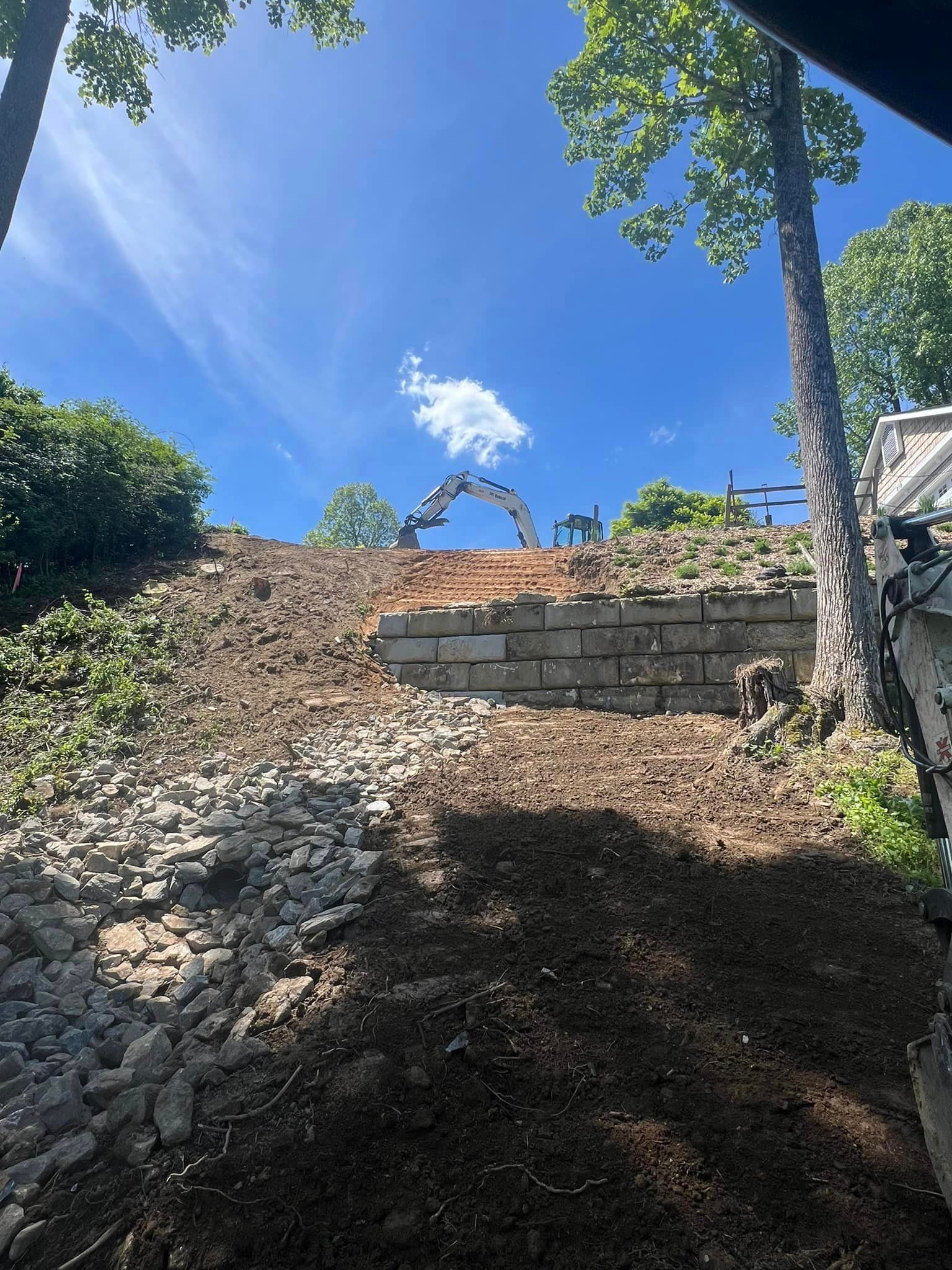 A large pile of dirt is sitting on top of a hill.