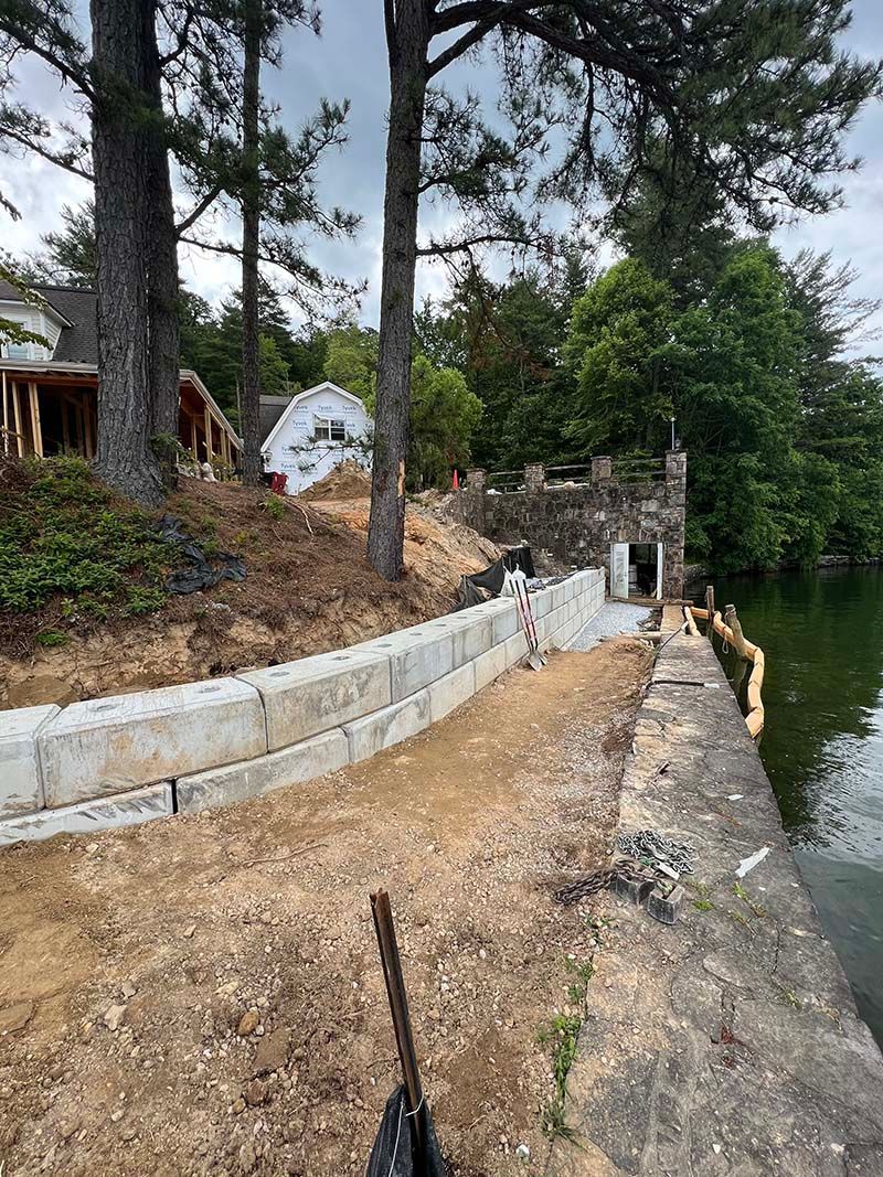 A concrete wall is being built next to a body of water.