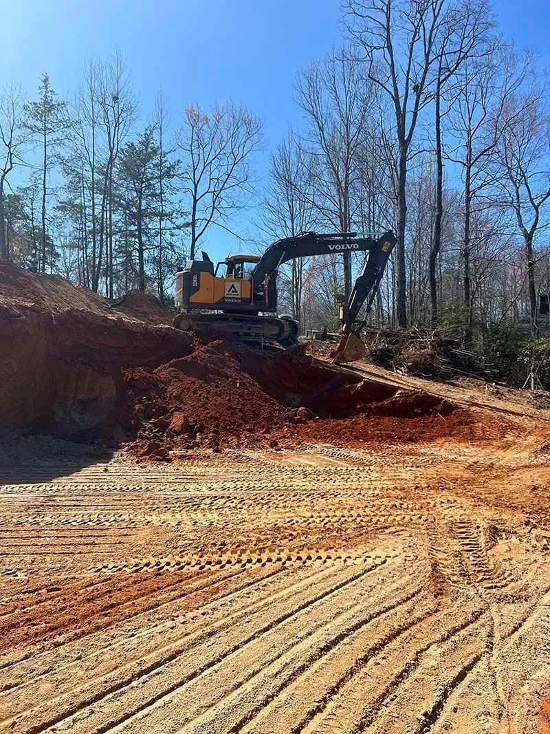 A bulldozer is digging a hole in the dirt on a construction site.