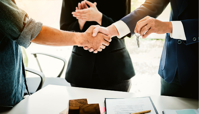 Group of People Shaking Hands — Ocala, FL — Invictus Real Estate, LLC