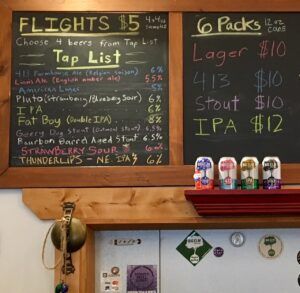 A chalkboard with a list of beers and tap list