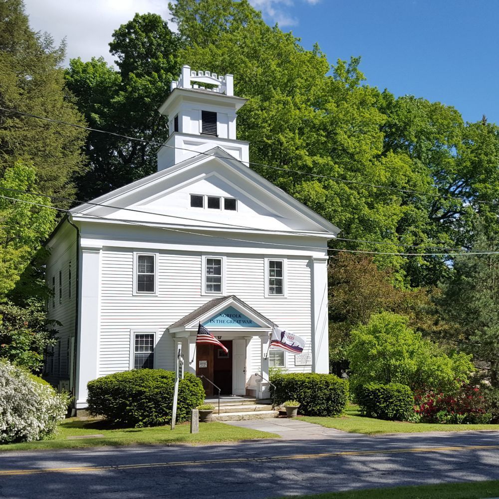 A white building with a tower on top of it