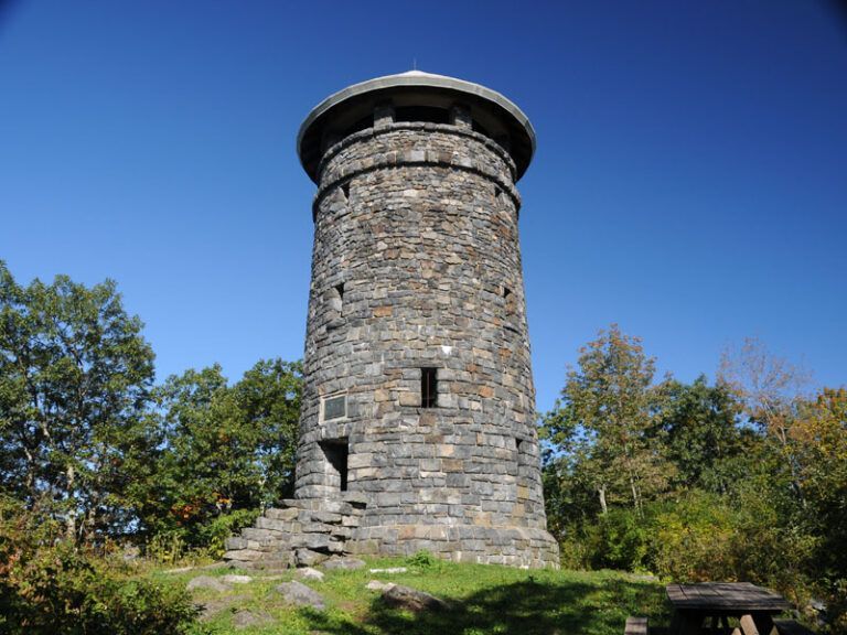 A stone tower with a blue sky in the background