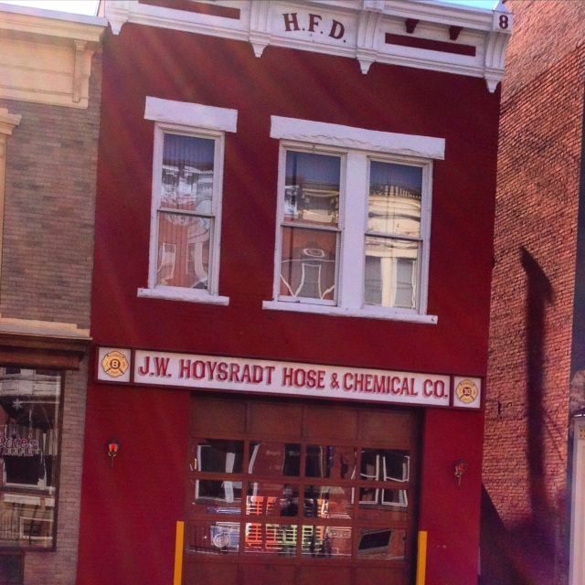 A red building with a sign that says j.w. hoysradt hose & chemical co.