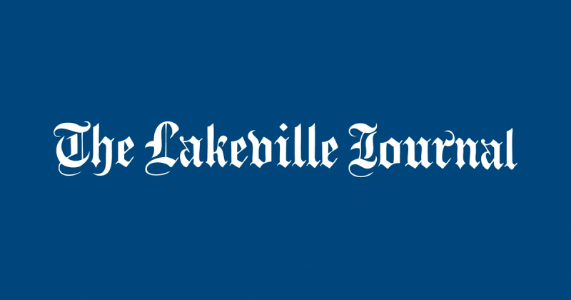 The lakeville journal logo on a blue background