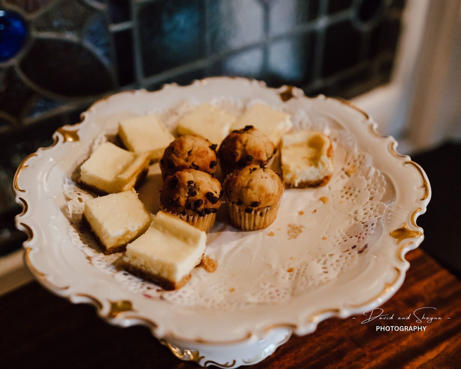 A plate of fresh-baked desserts on a wooden table.