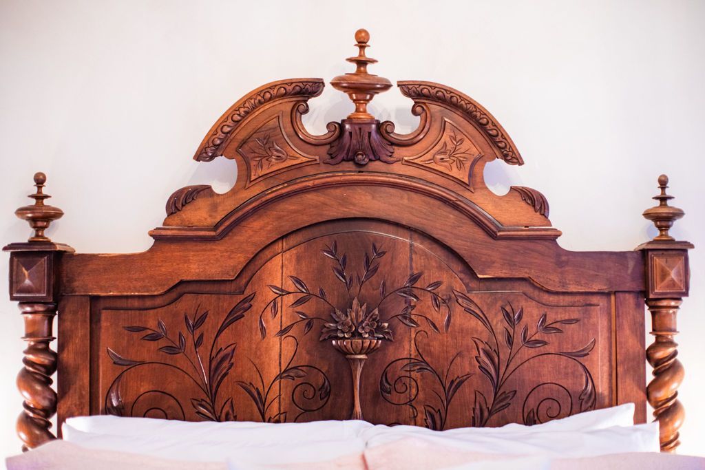 A bed with a wooden headboard and pillows on it