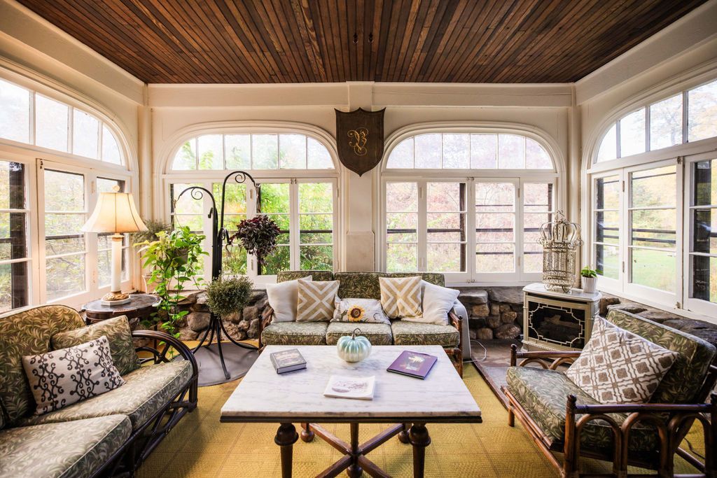 A living room with a lot of furniture and a wooden ceiling.